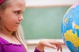 Close up of a schoolgirl looking at a globe