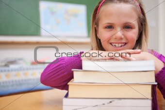 Schoolgirl posing with a stack of books