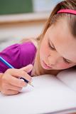 Portrait of a young schoolgirl writing
