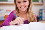 Close up of a young schoolgirl writing