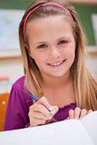 Portrait of a little schoolgirl writing