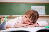 Schoolgirl sleeping on a desk