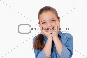 Girl posing with her hands under her chin