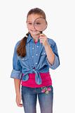 Portrait of a girl looking through a magnifying glass