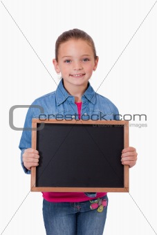 Portrait of a young girl holding a school slate