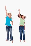 Portrait of girls jumping with their fists up