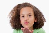 Close up of a girl blowing a kiss