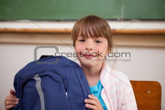 Happy schoolgirl posing with a bag
