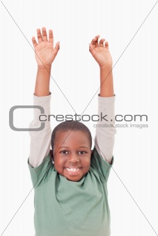 Portrait of a boy raising his arms