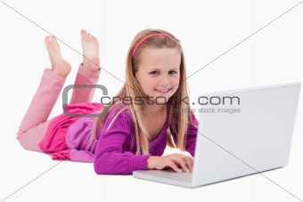 Smiling girl using a notebook