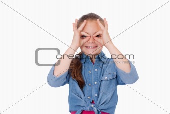 Girl with her fingers around her eyes