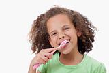 Smiling girl brushing her teeth