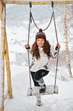 Young Beautiful Woman in winter time and swing