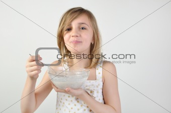 child with a bowl of milk porridge