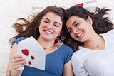 Girls having fun reading love letter together