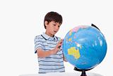 Boy looking at a globe