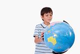 Smiling boy looking at a globe