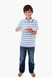 Portrait of a cute smiling boy using a tablet computer