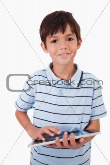 Portrait of a cute little boy using a tablet computer