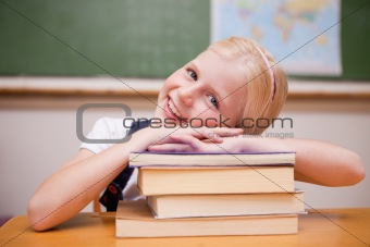 Smiling girl leaning on books