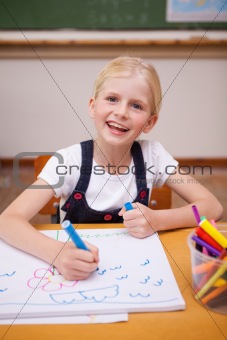 Portrait of a smiling girl drawing