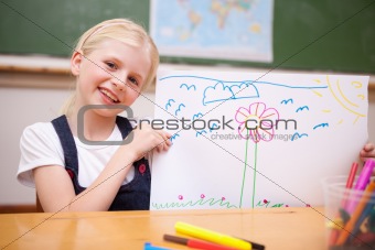 Smiling girl showing her drawing