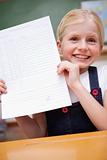 Portrait of a girl showing her school report