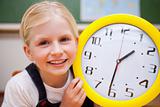 Schoolgirl showing a clock