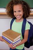 Portrait of a schoolgirl holding her books