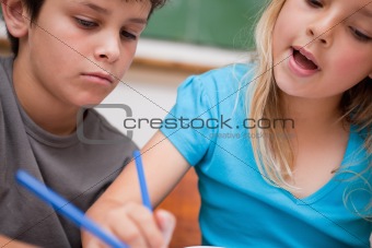 Close up of two children writing