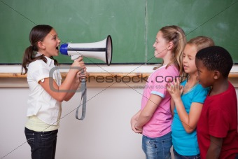 Schoolgirl yelling through a megaphone to her classmates