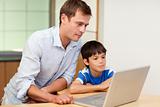 Father and son looking at laptop