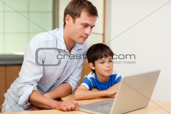 Father and son looking at laptop