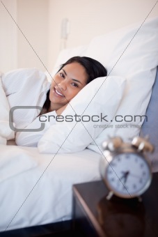 Side view of woman lying in the bed