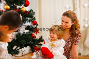 Family spending time near Christmas tree