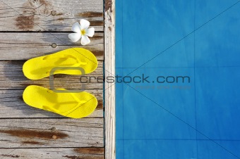 Sandals by a swimming pool 