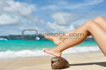Women's legs on a beach