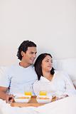 Couple eating breakfast in the bed
