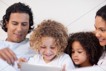 Family having a joyful time in the bed