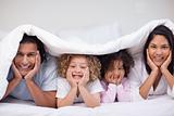 Family hiding under the blanket