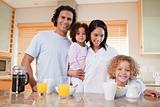 Happy family having breakfast in the kitchen together