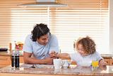 Father and daughter having breakfast in the kitchen together