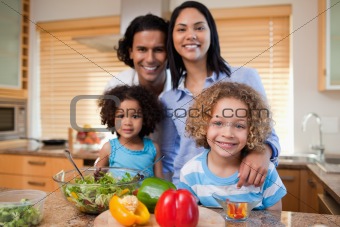Family preparing salad together