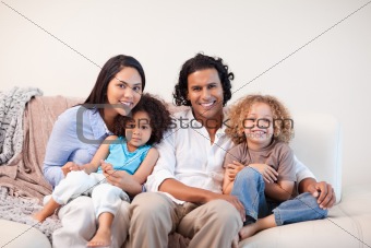 Cheerful family sitting on the sofa together