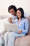 Couple on the sofa surfing the internet together