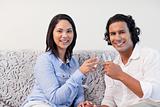 Couple having sparkling wine on the sofa