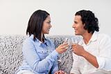 Couple having sparkling wine on the couch