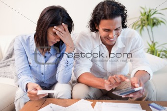 Couple checking their bills in the living room