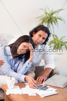 Depressed couple checking their bills