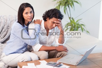 Couple on the sofa doing their calculations